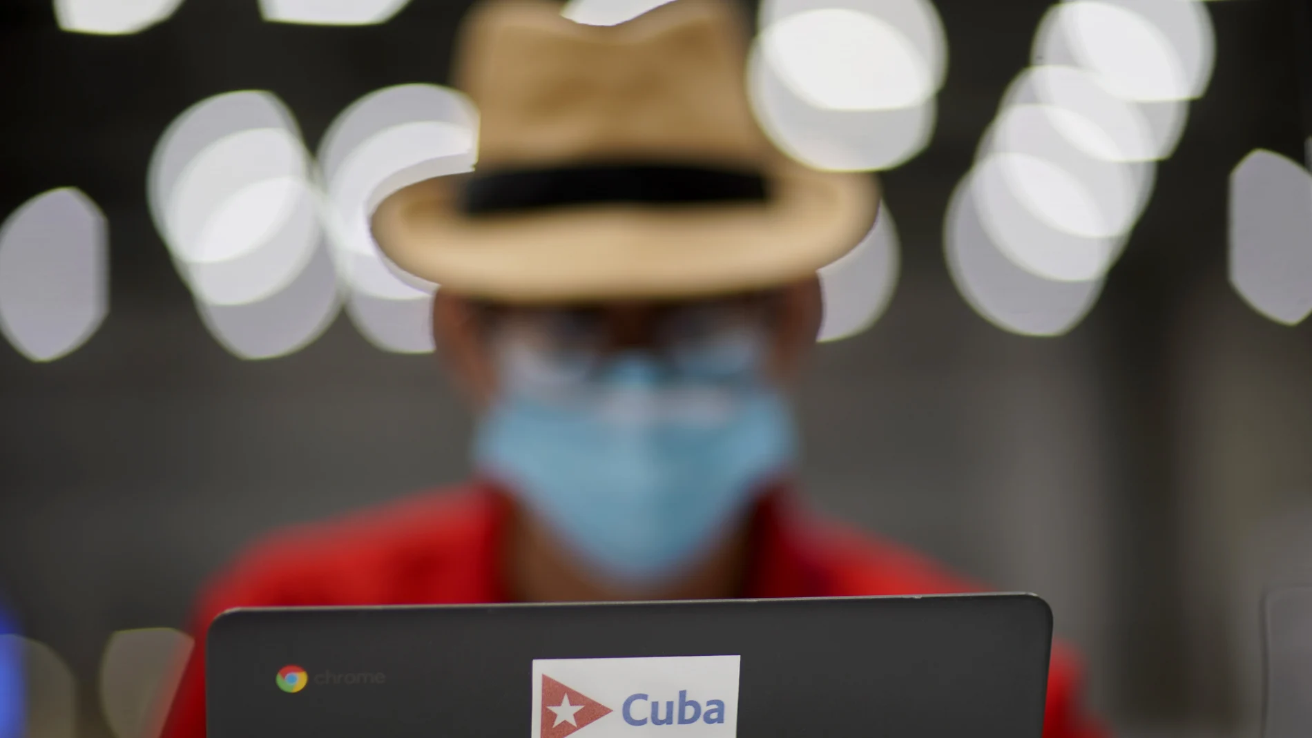 Norland Rosendo Gonzalez, a journalist with Periodico Juventud Rebelde in Cuba, works in the main press center at the 2020 Summer Olympics, Tuesday, July 20, 2021, in Tokyo. (AP Photo/David Goldman)