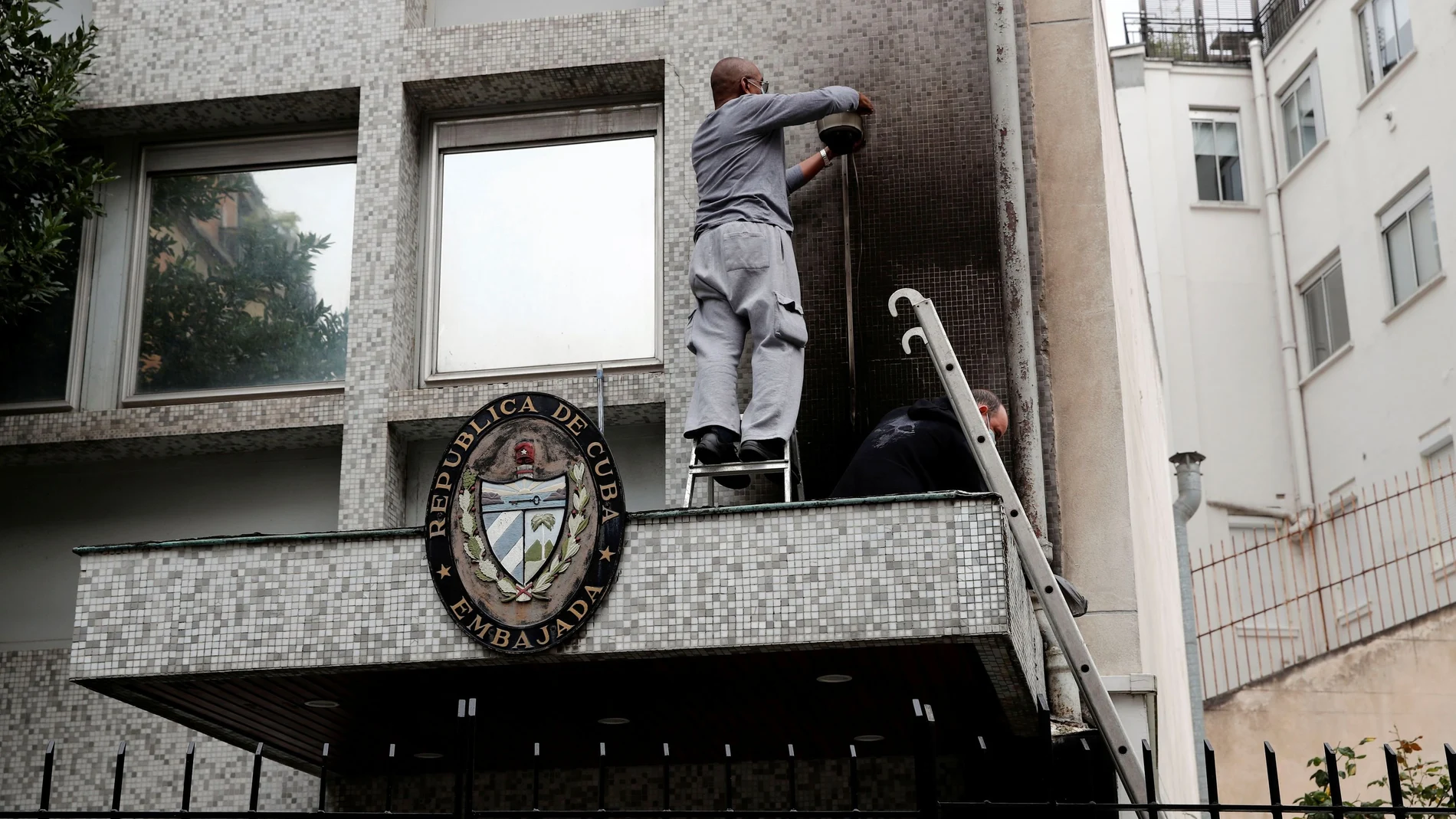 Experts inspect the damage at the Cuban embassy following an overnight petrol bomb attack on its building, in Paris, France July 27, 2021. REUTERS/Benoit Tessier
