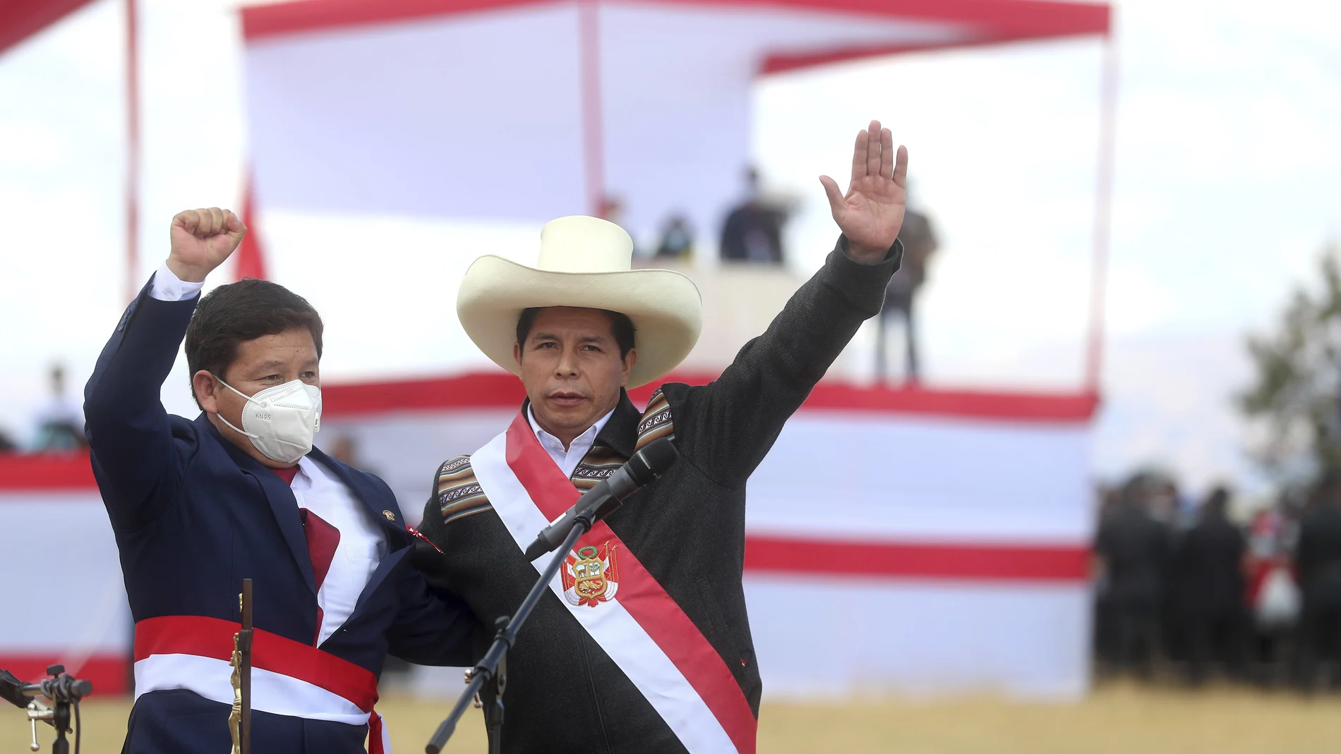 Peru's President Pedro Castillo, right, and his Prime Minister Guido Bellido pose for photos after a symbolic swearing-in ceremony at the site of the 1824 Battle of Ayacucho, which sealed independence from Spain, at the Pampa de la Quinua as part of PeruÂ´s bicentennial celebrations in Ayacucho, Peru, Thursday, July 29, 2021, the day after he was officially sworn in as president. (AP Photo/Ernesto Arias)