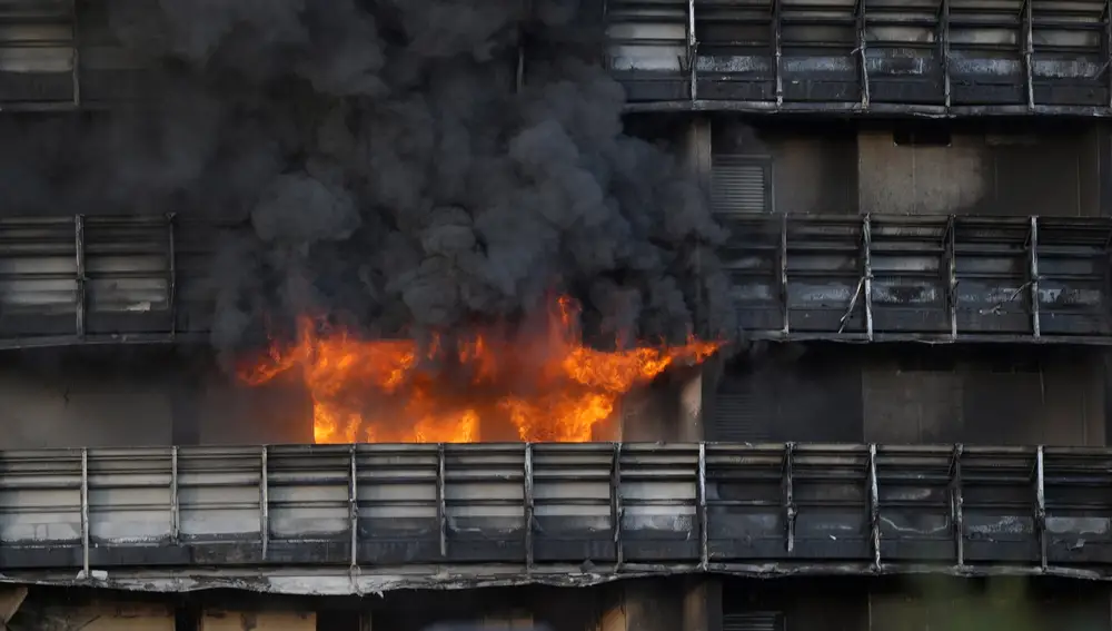 Smoke billows from a building in Milan, Italy, Sunday, Aug. 29, 2021. Firefighters were battling a blaze on Sunday that spread rapidly through a recently restructured 60-meter-high, 16-story residential building in Milan. There were no immediate reports of injuries or deaths. (AP Photo/Luca Bruno)