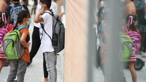 Varios niños esperan a la puertas del colegio Les Arts, de reciente construcción, durante el primer día del curso escolar 2021-2022 en la Comunidad Valenciana