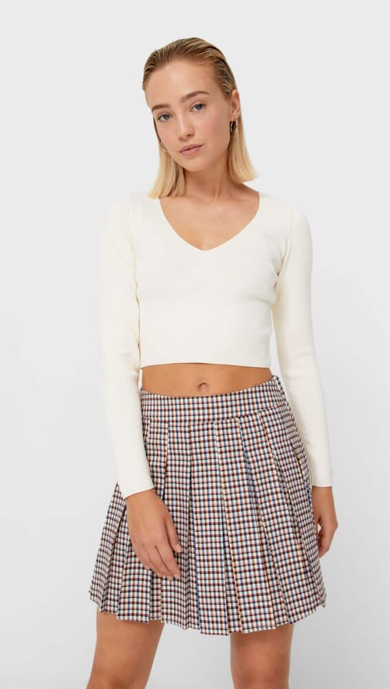 Blazer + falda de tablas, la combinación que te transporta a tu