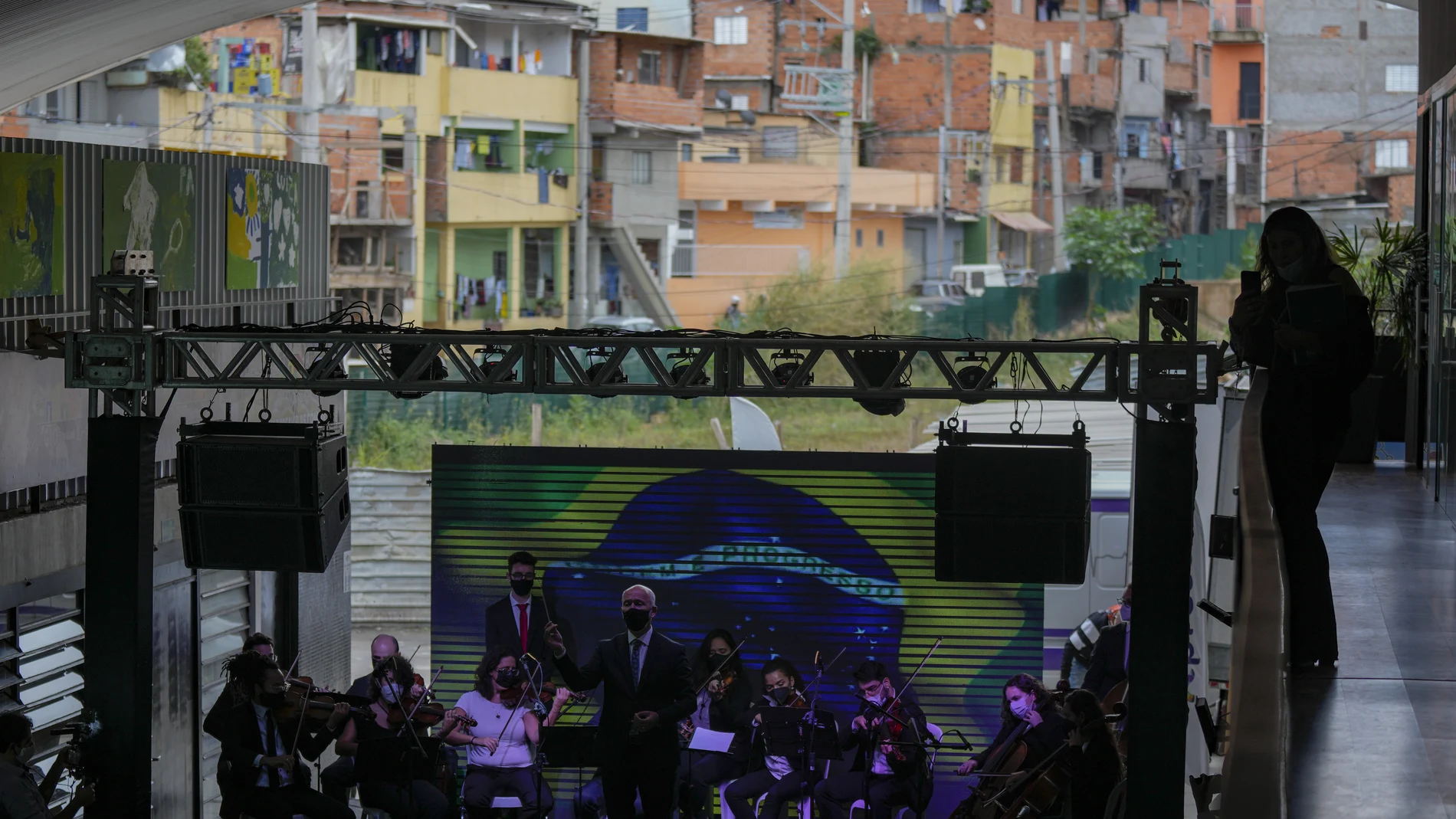 Musicians residents in the Paraisopolis favela, as part of the community's centennial celebration, in Sao Paulo, Brazil, Thursday, Sept. 16, 2021. One of the largest favela's in Brazil, home to tens of thousands of residents in the country's largest and wealthiest city, Paraisopolis is grappling with crime and a pandemic that have challenged daily life for many who live there, but organizers say its people have built a vibrant community and are launching a 10-day celebration of its achievements. (AP Photo/Andre Penner)
