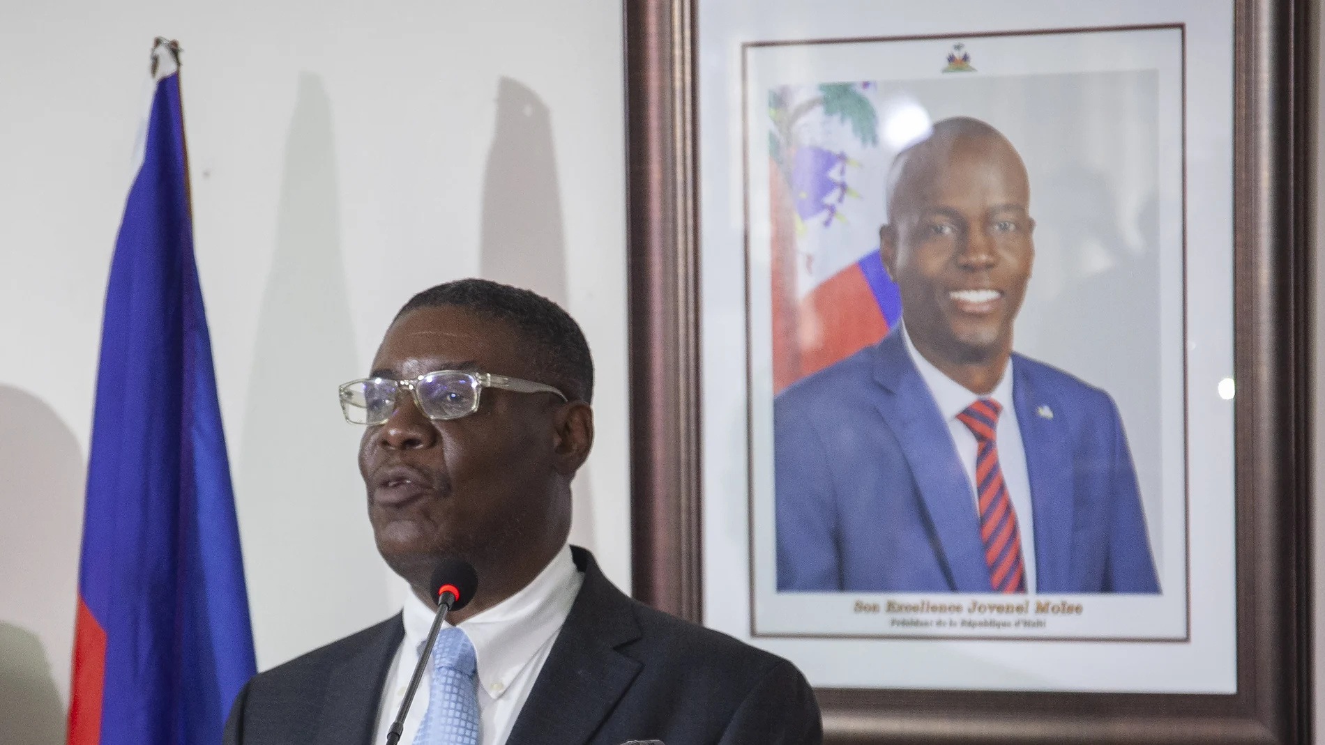 Haiti's newly-named Justice Minister Liszt Quitel, speaks during his installation ceremony, backdropped by a photo of assassinated President Jovenel Moise, in Port-au-Prince, Haiti, Thursday, Sept. 16, 2021. (AP Photo/Richard Pierrin)