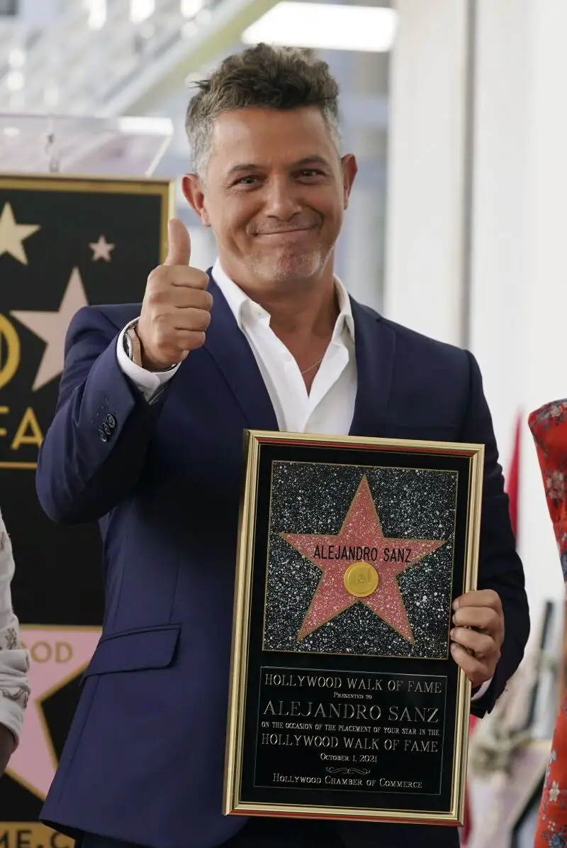 Spanish musician Alejandro Sanz holds a replica of his new star on the Hollywood Walk of Fame following a ceremony, Friday, Oct. 1, 2021, in Los Angeles. (AP Photo/Chris Pizzello)