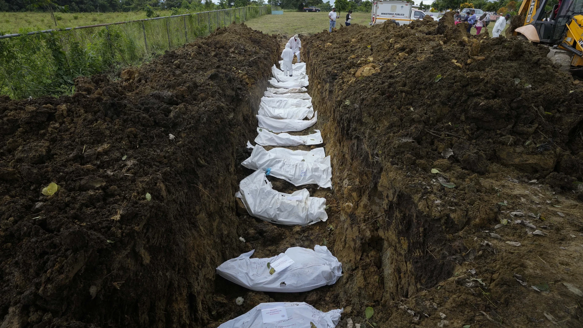 A forensics team burys a group of migrants who died trying to cross the Darien gap, at the Guayabillo cemetery in Agua Fria, Panama, Thursday, Sept. 30, 2021. (AP Photo/Arnulfo Franco)