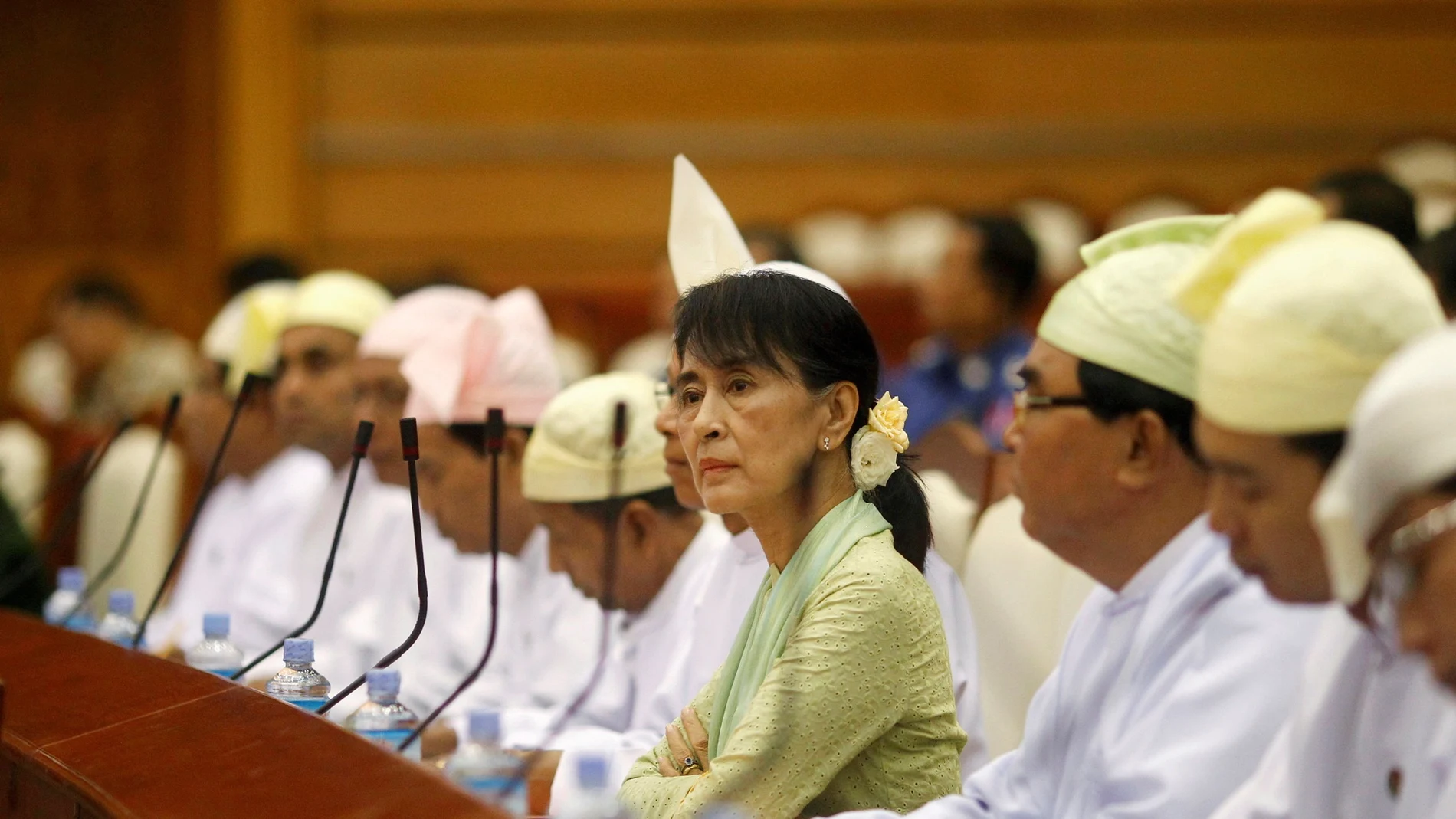 FILE PHOTO: Myanmar pro-democracy leader Aung San Suu Kyi (C) attends a parliamentary meeting at the Lower House of Parliament in Naypyitaw July 9, 2012. REUTERS/Soe Zeya Tun/File Photo/File Photo