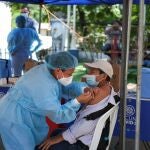 A healthcare worker applies a dose of a coronavirus disease (COVID-19) vaccine at a mobile vaccination center in Panchimalco, El Salvador, October 5, 2021. REUTERS/Jose Cabezas