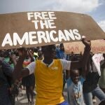 People protest for the release of kidnapped missionaries near the missionaries' headquarters in Titanyen, north of Port-au-Prince, Haiti, Tuesday, Oct. 19, 2021. A group of 17 U.S. missionaries including children was kidnapped by a gang in Haiti on Saturday, Oct. 16, according to a voice message sent to various religious missions by an organization with direct knowledge of the incident. (AP Photo/Joseph Odelyn)