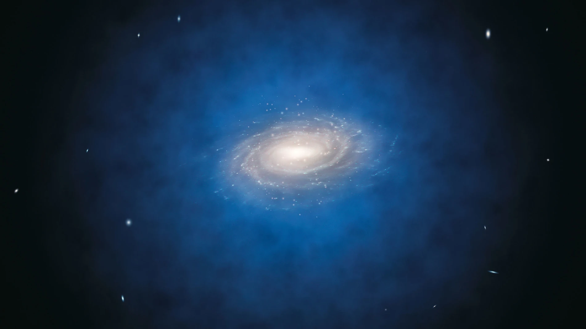 Una representación artística de la Vía Láctea, con la nube de materia oscura en la que está inmersa coloreada en azul. Todo indica que las galaxias se forman en el corazón de estas nubes, o “halos”, cuya extensión puede ser muy variable. En algunos casos el halo puede ser hasta diez veces más grande que la propia galaxia.