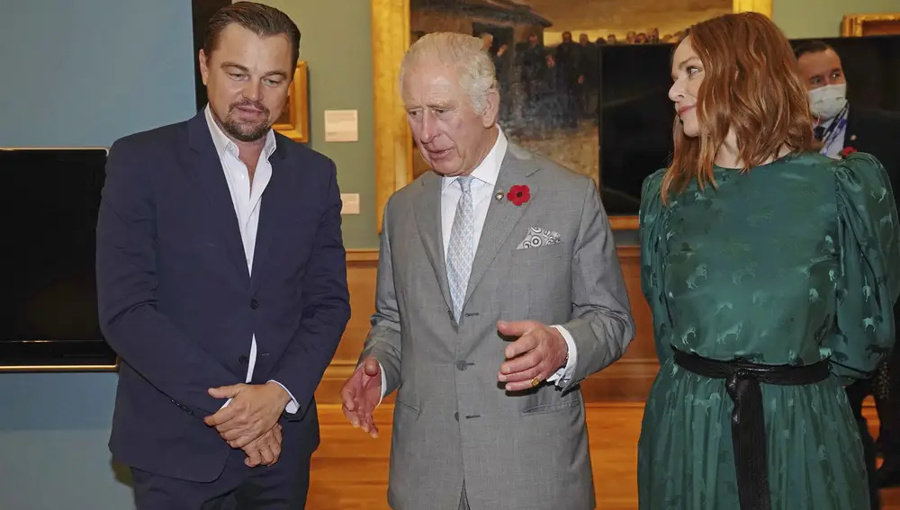 Britain's Prince Charles, center, speaks with designer Stella McCartney, right, and Leonardo DiCaprio, left, as he views a fashion installation by the designer, at the Kelvingrove Art Gallery and Museum, during the Cop26 summit being held at the Scottish Event Campus (SEC) in Glasgow, Scotland, Wednesday, Nov. 3, 2021. (Owen Humphreys/Pool via AP)