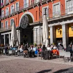 Varias personas sentadas en una terraza, en Madrid, (España).