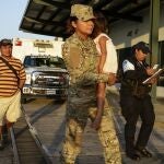 FILE - Jose Gonzalez, left, follows his 5-year-old daughter, carried by a police officer, as they leave a hospital in Santiago, Panama, Thursday, Jan. 16, 2020. Gonzalez's wife and five of their children are among seven people killed in a religious ritual in the Ngabe Bugle indigenous community. On Saturday, Nov. 20, 2021, a jury of conscience convicted seven members of a religious sect accused of murdering a woman and six minors as part of a cult in a remote indigenous area of â€‹â€‹the Panamanian Caribbean in early 2020, a tragedy that strongly shook the country. (AP Photo/Arnulfo Franco, File)