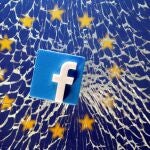 A 3D printed Facebook logo is placed on broken glass above a printed EU flag in this illustration
