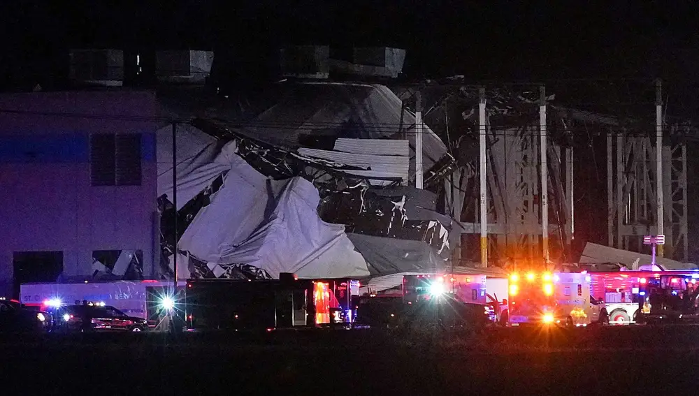 Emergency vehicles surround the site of an Amazon.com distribution warehouse with a collapsed roof, after storms hit the area of Edwardsville, Illinois, U.S. December 10, 2021. REUTERS/Lawrence Bryant