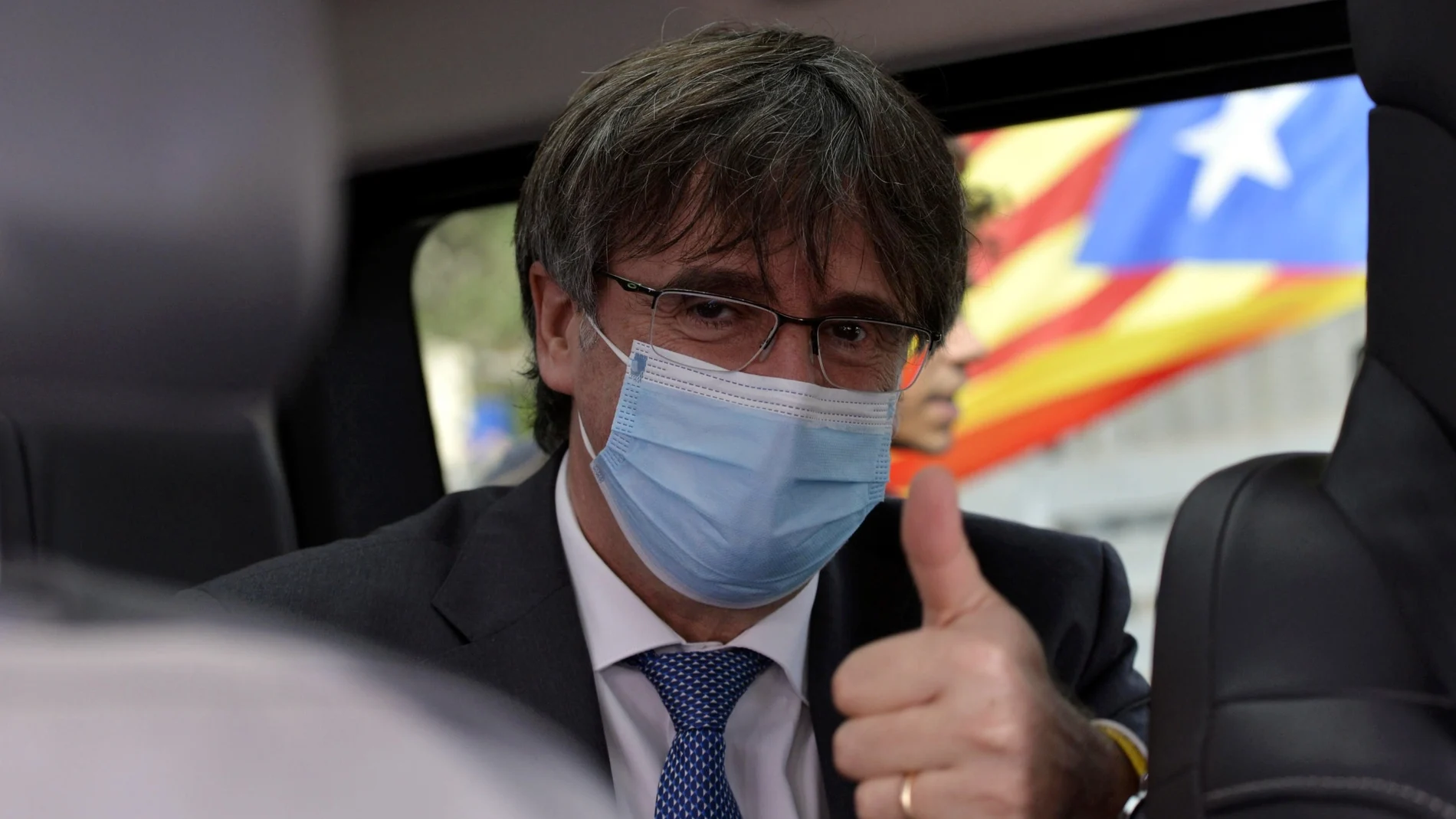 Exiled Catalan separatist leader Carles Puigdemont leaves the appeals court at the end of the hearing, in Sassari, Sardinia