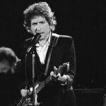 FILE - Musician Bob Dylan performs with The Band at the Forum in Los Angeles on Feb. 15, 1974. Transcripts of lost 1971 Dylan interviews with the late American blues artist Tony Glover and letters the two exchanged reveal that Dylan changed his name from Robert Zimmerman because he worried about anti-Semitism, and that he wrote "Lay Lady Lay" for actress Barbra Streisand. The items are among a trove of Dylan archives being auctioned in November 2020 by Boston-based R.R. Auction. (AP Photo/Jeff Robbins, File)
