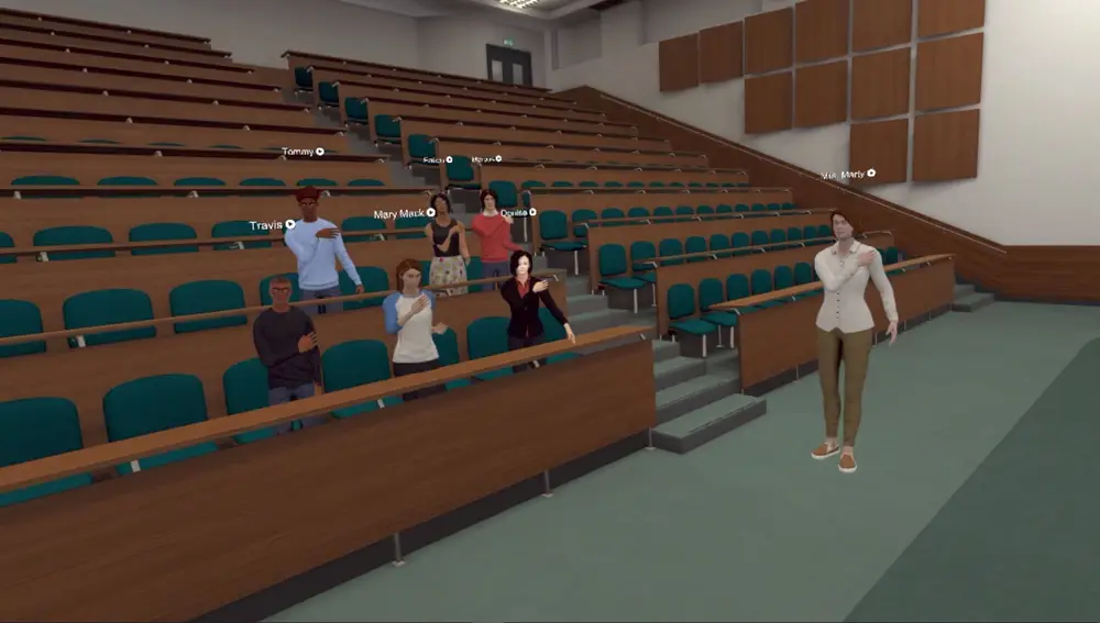 Fotografía cedida por Optima Classical Academy que muestra una de sus clases de realidad virtual 3D donde aparece una profesora mientras imparte su clase a unos alumnos en un anfiteatro.