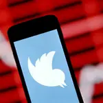 FILE PHOTO: The Twitter logo is shown on smartphone in front of a displayed stock graph in central Bosnian town of Zenica, Bosnia and Herzegovina, in this April 29, 2015 photo illustration. REUTERS/Dado Ruvic/File Photo