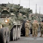 Soldados del 2º Regimiento de Caballería de Estados Unidos conversa junto a varios vehículos militares antes de partir a Rumanía, en la Base Aérea estadounidense de Vilseck (Alemania)