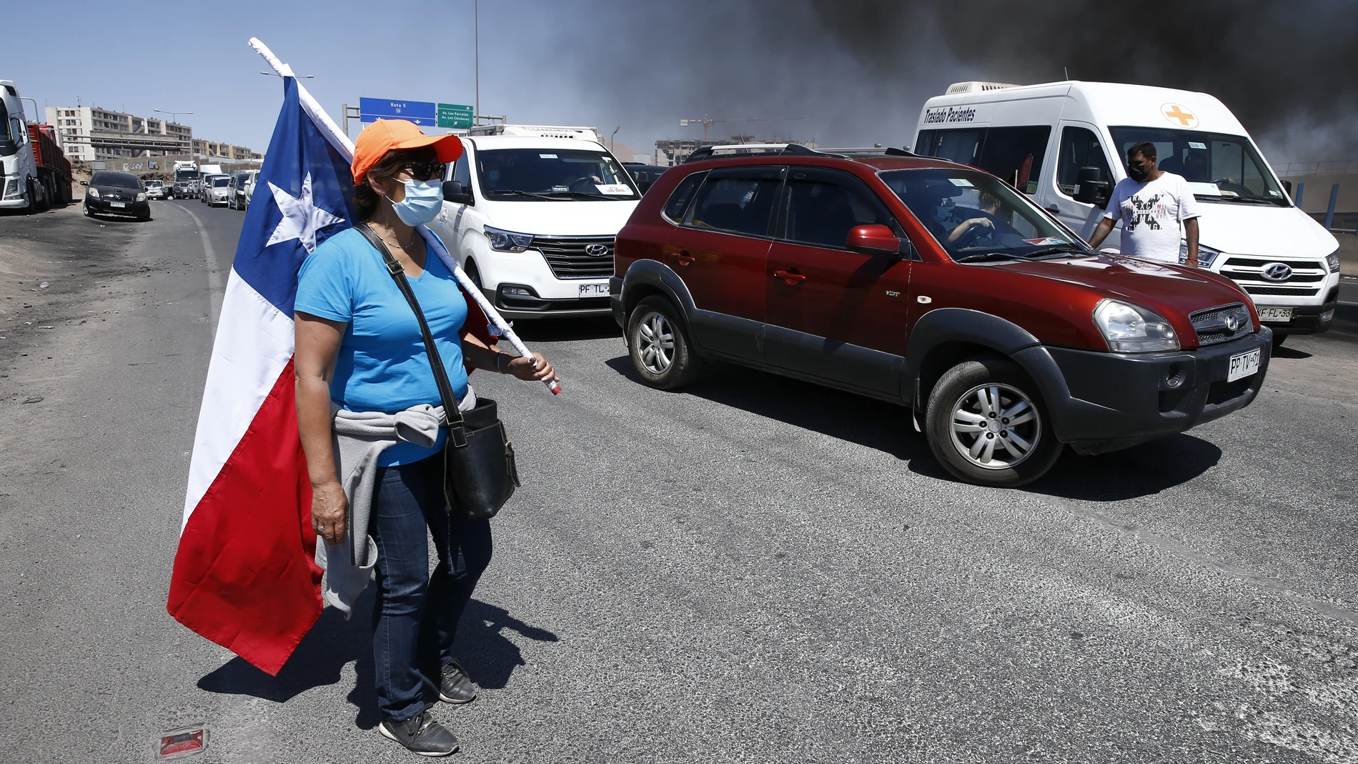 Vehículos detenidos por una barricada puesta por manifestantes durante protestas este sábado en Iquique, Chile