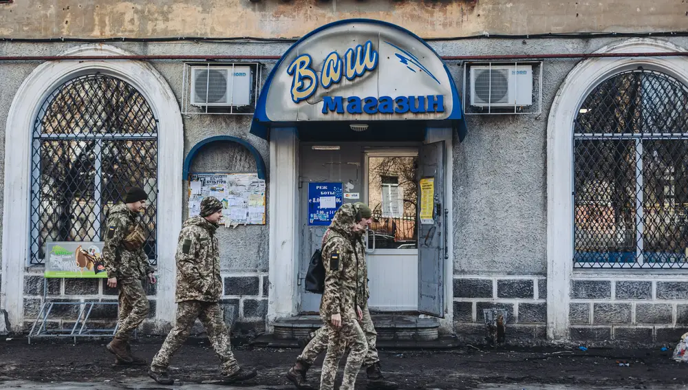 Unos soldados caminan delante de una tienda local, a 23 de febrero de 2022, en Chasiv Yar, Oblast de Donetsk (Ucrania) | Fuente: Diego Herrera / Europa Press