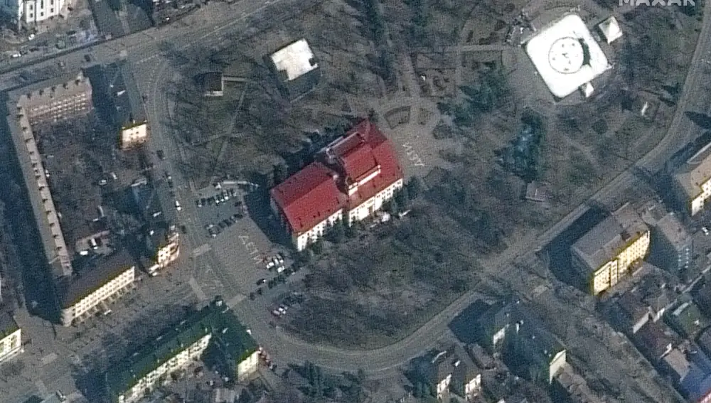 This satellite image provided by Maxar Technologies shows the Mariupol Drama Theater in Mariupol, Ukraine on Monday, March 14, 2022. Ukrainian officials say Russian forces destroyed the theater in the city of Mariupol where hundreds of people were sheltering. There was no immediate word on deaths or injuries in what the Mariupol city council said was an airstrike on the theater Wednesday. The Maxar satellite imagery firm said images from Monday showed the word â€œchildrenâ€ had been written in large white letters in Russian in front of and behind the building. (Maxar Technologies via AP)