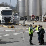 Dos agentes de la Guardia Civil vigilan un bloqueo de una fábrica de leche en Meira, a 18 de marzo de 2022, en Meira, Lugo, Galicia