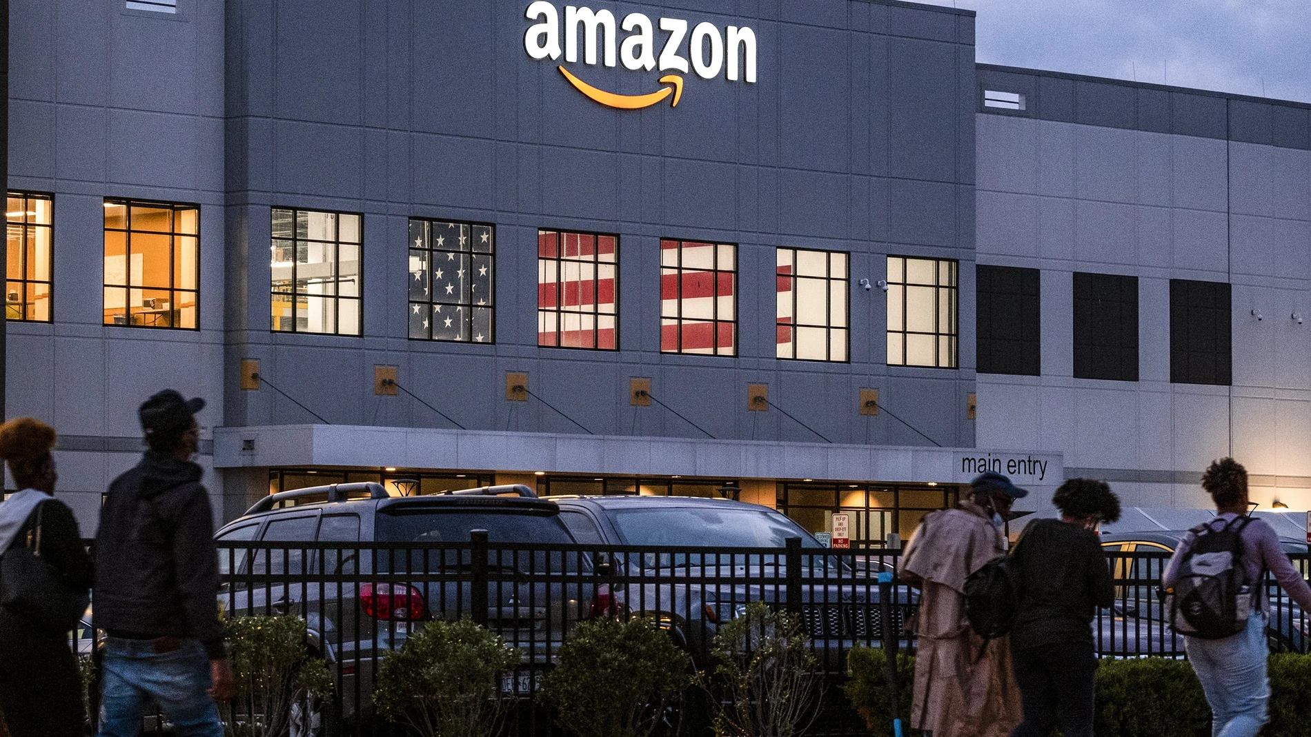FILE - People arrive for work at the Amazon distribution center in the Staten Island borough of New York, Monday, Oct. 25, 2021. A federal labor board says a second Amazon warehouse in the New York City borough of Staten Island will have a union election in April 2022. (AP Photo/Craig Ruttle, File)