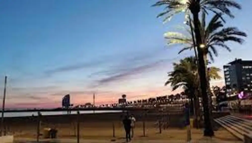Playa de la Barceloneta con la silueta al fondo del famoso edificio del Hotel W en Barcelona