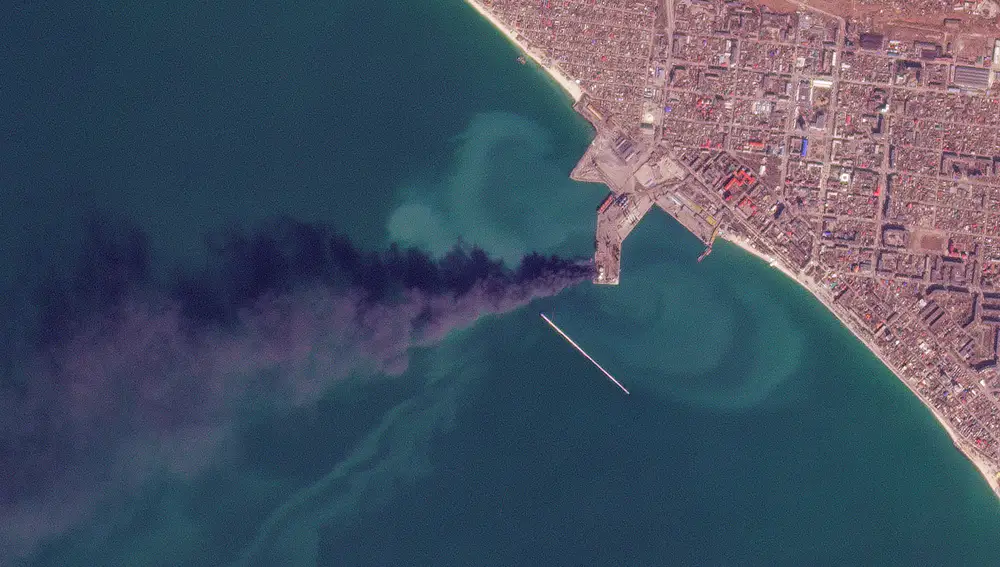 En esta foto de satélite de Planet Labs PBC, el humo se eleva después de un ataque que Ucrania dijo que hundió un gran barco de desembarco ruso en la ciudad portuaria de Berdyansk
