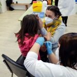Una madre acompaña a su hija mientras la vacunan en el CEIP Blasco de Alagón de Vilafranca