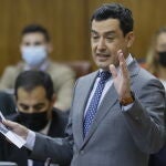 El presidente andaluz, Juanma Moreno, muestra un documento en una de sus intervenciones en la sesión de control al Ejecutivo autonómico