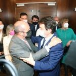 Pedro Rollán saluda a Fernández Mañueco tras presentar su programa en el debate de investidura