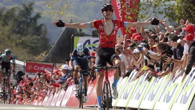 Dylan Teuns levanta los brazos al entrar vencedor en meta con Alejandro Valverde al fondo