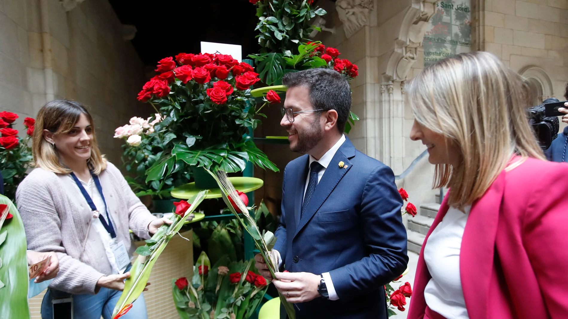 El presidente de la Generalitat, Pere Aragonès, y su pareja Janina Juli Pujol (d), reciben una rosa.