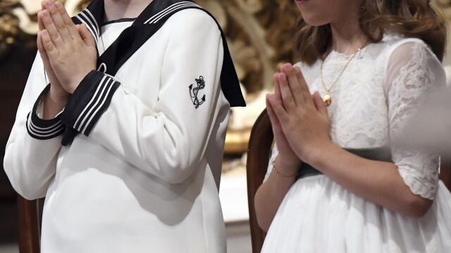 Un niño y una niña antes de tomar la primera comunión