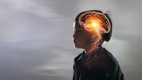 Niño con los ojos cerrados y un gráfico de su cerebro
