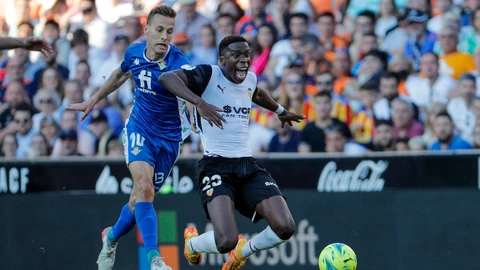 El centrocampista hispano-guineano del Valencia Ilaix Moriba (d) disputa el balón ante Sergio Canales (i), centrocampista del Betis, durante el encuentro de la jornada 36 entre el Valencia CF y el Real Betis, este martes en el estadio de Mestalla en Valencia. EFE/ Manuel Bruque