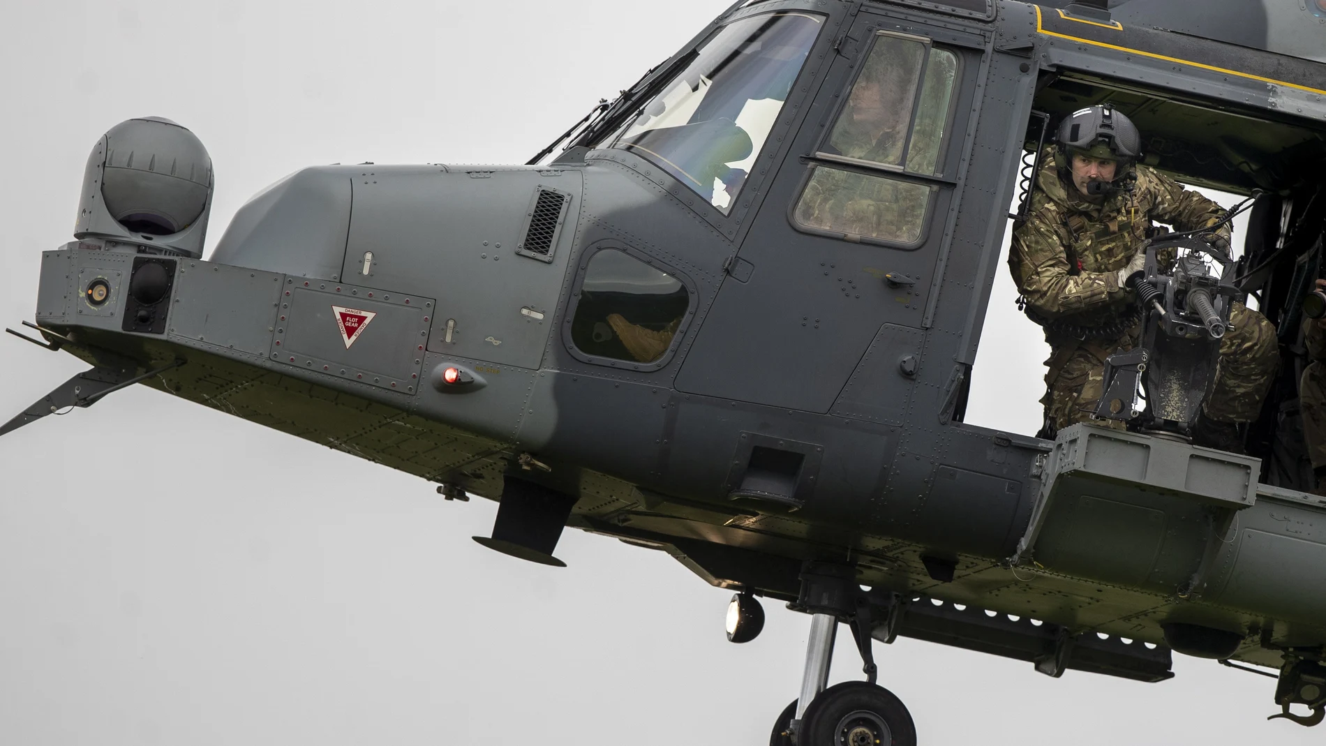 Un soldado del Ejército británico mira hacia abajo desde un helicóptero AgustaWestland AW159 Wildcat durante el ejercicio militar de la OTAN "Flaming Sword 2022" en un campo de entrenamiento cerca del pueblo Maisiejunai, a unos 96 km al oeste de la capital lituana