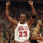 FILE - In this June 14, 1992, file photo, Michael Jordan celebrates the Bulls win over the Portland Trail Blazers in the NBA Finals in Chicago. Decades after Jordan's groundbreaking departure from college, March Madness and the NBA's mega-millions have taken all the novelty out of leaving early for the pros. (AP Photo/John Swart, File)