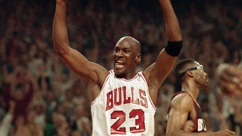 FILE - In this June 14, 1992, file photo, Michael Jordan celebrates the Bulls win over the Portland Trail Blazers in the NBA Finals in Chicago. Decades after Jordan's groundbreaking departure from college, March Madness and the NBA's mega-millions have taken all the novelty out of leaving early for the pros. (AP Photo/John Swart, File)