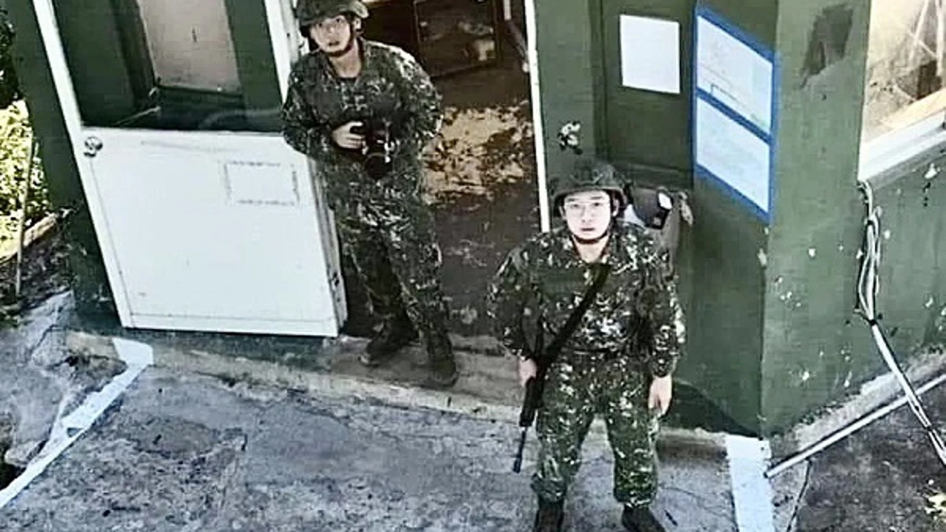 Dos soldados taiwaneses ante la presencia de un dron chino sobre una base militar en una isla de Taiwán