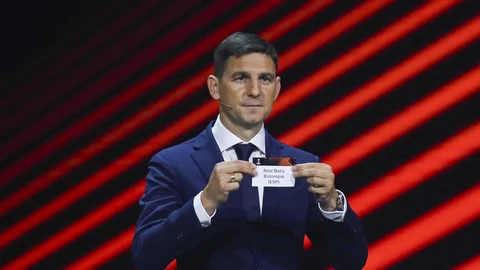 Hungarian former player Zoltan Gera shows the name of Real Betis during the soccer Europa League draw in Istanbul, Turkey, Friday, Aug. 26, 2022. (AP Photo/Emrah Gurel)