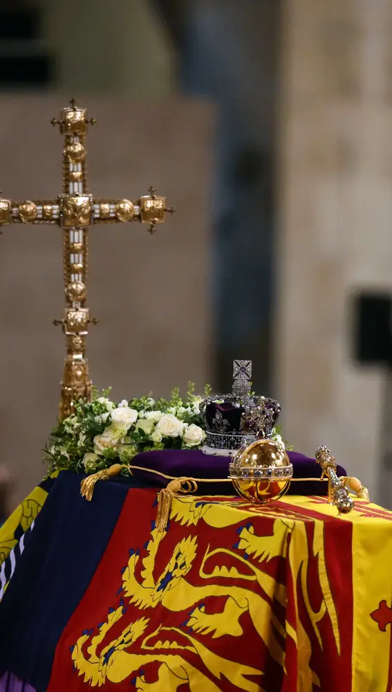 The coffin of Queen Elizabeth II, draped in the Royal Standard with the Imperial State Crown and the Sovereign's orb and sceptre, lying in state on the catafalque in Westminster Hall, at the Palace of Westminster in London, Friday Sept. 16, 2022. (Daniel Leal/Pool Photo via AP)