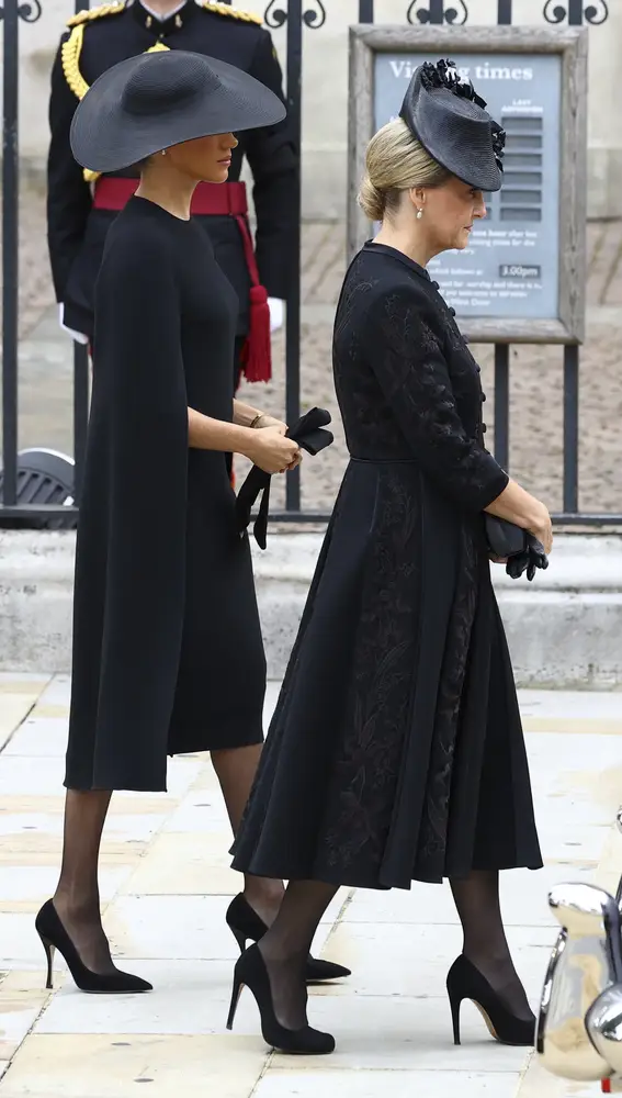 Britain's Sophie, Countess of Wessex, and Britain's Meghan, Duchess of Sussex walk outside the Westminster Abbey on the day of Queen Elizabeth II funeral, in London Monday, Sept. 19, 2022. (Hannah McKay/Pool Photo via AP)