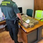 Agente de la Guardia Civil con el alijo incautado en la A-92. GUARDIA CIVIL