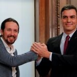 FILE PHOTO: Spain's acting PM Sanchez and Unidas Podemos leader Iglesias present their coalition agreement in Madrid