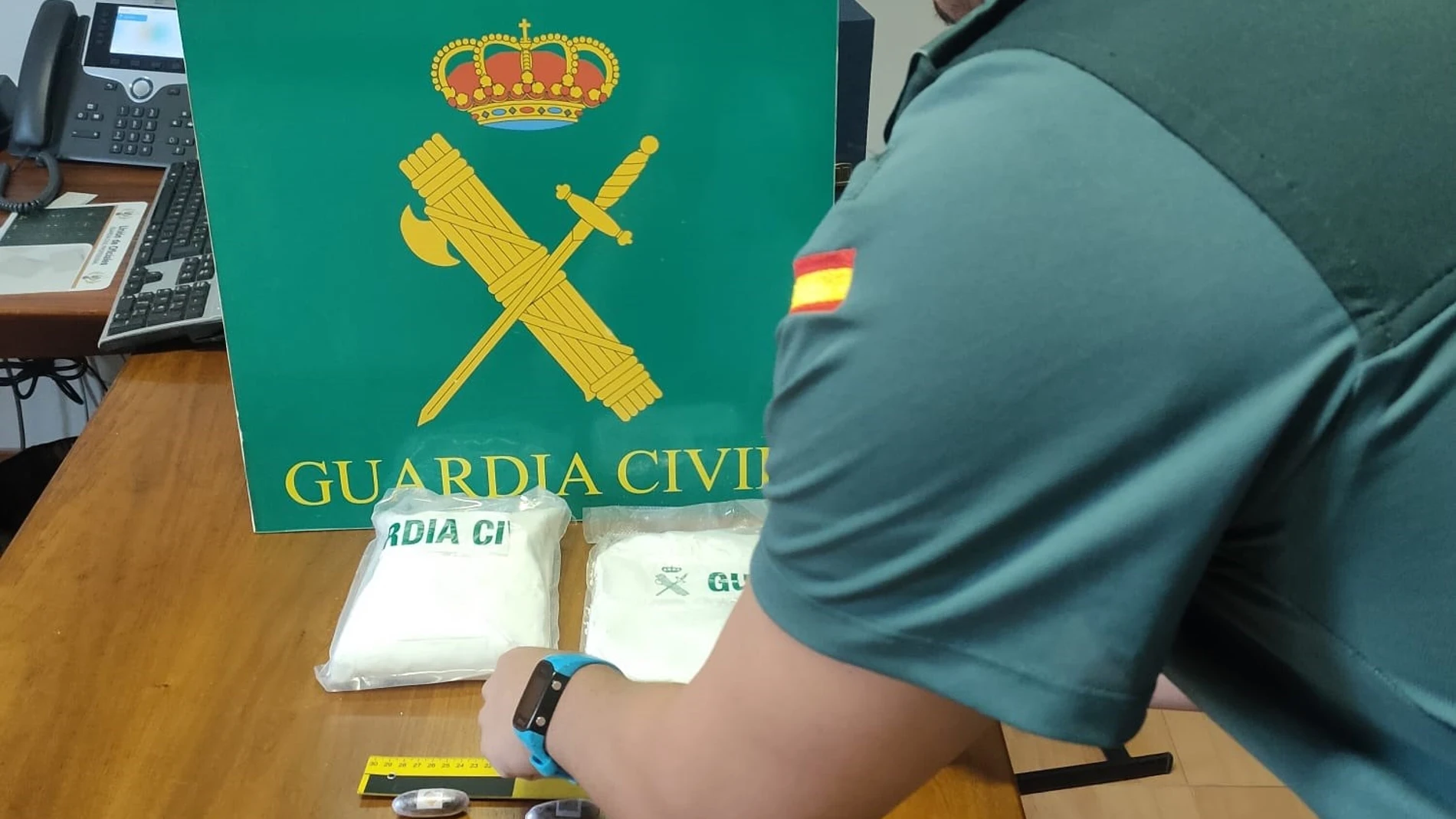 Agente de la Guardia Civil junto a la droga incautada. GUARDIA CIVIL