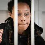 FILE - WNBA star and two-time Olympic gold medalist Brittney Griner speaks to her lawyers standing in a cage at a court room prior to a hearing, in Khimki just outside Moscow, Russia, Tuesday, July 26, 2022. A Russian court has on Tuesday, Oct. 23 started hearing American basketball star Brittney Griner&#39;s appeal against her nine-year prison sentence for drug possession. (AP Photo/Alexander Zemlianichenko, Pool, File)